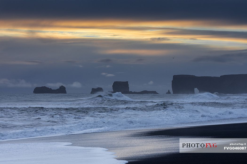 Reynisfjara black sand beach and  Dyrhlaey promontory in the storm, Myrdalur, Iceland